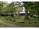 Landscaped yard with large rocks and mature trees at 9100 S Us Highway 35, Muncie, IN 47302