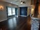 Living room with dark hardwood floors, accent wall, and high ceilings at 1344 Barth Ave, Indianapolis, IN 46203
