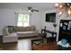 Spacious living room with L-shaped sofa and hardwood floors at 2312 E 22Nd St, Muncie, IN 47302