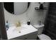 Modern bathroom with gold fixtures and a round mirror at 2312 E 22Nd St, Muncie, IN 47302