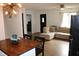 Open concept living and kitchen area with L-shaped sofa and hardwood floors at 2312 E 22Nd St, Muncie, IN 47302