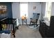 Bedroom with crib, dresser, and rocking chair in a blue and gray theme at 2312 E 22Nd St, Muncie, IN 47302