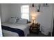 Bright bedroom with a queen bed and a bedside table at 2312 E 22Nd St, Muncie, IN 47302