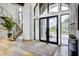 Bright and airy entryway with hardwood floors, floating staircase and large windows at 9760 Windy Hills Dr, Zionsville, IN 46077