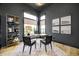 Luxurious home office with built-in shelving and large windows at 9760 Windy Hills Dr, Zionsville, IN 46077