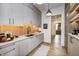 Bright butler's pantry featuring orange tile backsplash and wood flooring at 9760 Windy Hills Dr, Zionsville, IN 46077