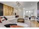 Spacious living area with sectional sofa, statement wall, and large windows at 9760 Windy Hills Dr, Zionsville, IN 46077