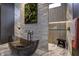 Spa-inspired bathroom with a unique stone feature wall at 9760 Windy Hills Dr, Zionsville, IN 46077