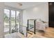 Modern staircase with glass railing and views to backyard at 9760 Windy Hills Dr, Zionsville, IN 46077