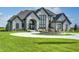 Elegant two-story home with circular driveway and fountain at 9760 Windy Hills Dr, Zionsville, IN 46077