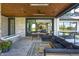 Covered patio boasts a stone fireplace, dining area and comfortable seating at 9760 Windy Hills Dr, Zionsville, IN 46077