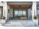 Covered patio with seating area and glass doors, leading to the interior at 9760 Windy Hills Dr, Zionsville, IN 46077