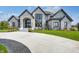 Luxury home with stone exterior and circular driveway at 9760 Windy Hills Dr, Zionsville, IN 46077