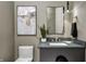 Elegant powder room with dark vanity and modern fixtures at 9760 Windy Hills Dr, Zionsville, IN 46077