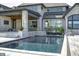 Luxury swimming pool with stone accents and a view of the house at 9760 Windy Hills Dr, Zionsville, IN 46077