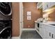 Bright laundry room with modern washer and dryer, and ample counter space at 9760 Windy Hills Dr, Zionsville, IN 46077