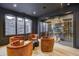 Elegant wine cellar with glass walls and comfortable seating at 9760 Windy Hills Dr, Zionsville, IN 46077