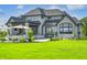Stunning two-story home with stone exterior, large windows and lush lawn at 9760 Windy Hills Dr, Zionsville, IN 46077