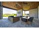 Covered patio with an outdoor kitchen and dining area at 9760 Windy Hills Dr, Zionsville, IN 46077