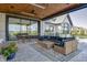 Covered patio features comfortable seating, dining table, and sliding glass doors leading to the interior at 9760 Windy Hills Dr, Zionsville, IN 46077