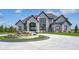 Elegant home exterior with stone facade and landscaping at 9760 Windy Hills Dr, Zionsville, IN 46077
