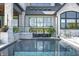 Inviting swimming pool with stone coping and waterfall feature at 9760 Windy Hills Dr, Zionsville, IN 46077