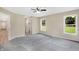 Bedroom with grey carpet, large windows, and access to a hallway at 10614 N 300 E, Morristown, IN 46161