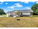 Ranch style home with gray siding, stone accents, and a two-car garage at 10614 N 300 E, Morristown, IN 46161