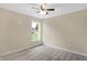 Bright bedroom with ceiling fan, carpet, and large window at 10614 N 300 E, Morristown, IN 46161