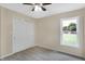 Bedroom with ceiling fan, carpet, window, and sliding closet doors at 10614 N 300 E, Morristown, IN 46161