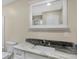 Bathroom with white vanity, granite countertop, and a large mirror at 10614 N 300 E, Morristown, IN 46161