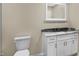 Bathroom with white vanity, granite countertop, and a large mirror at 10614 N 300 E, Morristown, IN 46161