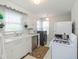 White kitchen with gas stove, microwave, and dishwasher at 1683 Conner St, Noblesville, IN 46060