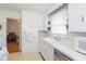 White kitchen with double sink, dishwasher and microwave at 1683 Conner St, Noblesville, IN 46060
