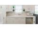 White kitchen with double sink, dishwasher and microwave at 1683 Conner St, Noblesville, IN 46060