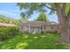 House back view, showcasing a screened porch and stone exterior at 1683 Conner St, Noblesville, IN 46060