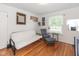 Bedroom with hardwood floors, rocking chair and window seat at 1683 Conner St, Noblesville, IN 46060