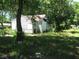 Small house exterior with overgrown yard at 3336 S Rybolt Ave, Indianapolis, IN 46221