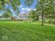 Landscaped backyard with pond and view of home exterior at 6935 Linden Woods Dr, Avon, IN 46123