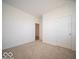 Empty bedroom with neutral carpet, white walls, and a closet at 5660 Cattail Branch Ln, Clayton, IN 46118