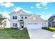 Two story home with neutral siding, white garage door, and landscaping at 19663 Atwater Ave, Sheridan, IN 46069