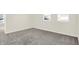 Simple bedroom with gray carpet and two windows at 19663 Atwater Ave, Sheridan, IN 46069