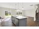 Modern kitchen with gray cabinets, island, stainless steel appliances, and hardwood floors at 19663 Atwater Ave, Sheridan, IN 46069