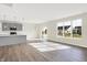Open concept kitchen and dining area with gray cabinets and island, hardwood floors, and view to backyard at 19663 Atwater Ave, Sheridan, IN 46069
