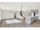 Spacious kitchen with gray cabinets, island, stainless steel appliances, and hardwood floors at 19663 Atwater Ave, Sheridan, IN 46069