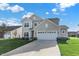 Two-story house with gray siding, white garage door, and landscaped lawn at 19663 Atwater Ave, Sheridan, IN 46069