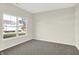 Simple bedroom with gray carpeting and a large window offering a street view at 19663 Atwater Ave, Sheridan, IN 46069