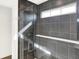 Sleek shower with dark tile and a frameless glass enclosure at 19663 Atwater Ave, Sheridan, IN 46069