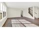 Spacious living room with hardwood floors, large windows, and staircase at 19663 Atwater Ave, Sheridan, IN 46069