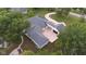 Aerial view showcasing home's unique design, large driveway, and landscaping at 3621 Olive Branch Rd, Greenwood, IN 46143
